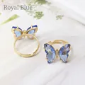 Elegant adjustable butterfly ring featuring royal blue crystal wings and gold finish - Sapphire Blue