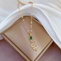 Collana a serpente in titanio dorato con occhi di gemma verde e pavé di diamanti - D104 Catena in Acciaio al Titanio Ciondolo in Rame