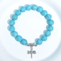 Blue turquoise beaded bracelet featuring a silver dragonfly charm on a white background - Blue Turquoise Dragonfly Charm