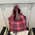 Pink and purple checkered tweed tote bag with frayed edges on a stylish black chair - Checkered Rose Red