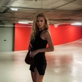 Slim fit sleeveless black dress paired with a deep red woven handbag in street style - S / Black
