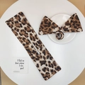 Close-up of leopard print bow scrunchie and fabric hair bun maker tool set - Large Brown Leopard Print