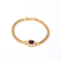 Golden Cuban chain bracelet featuring a purple oval gemstone and sparkling zircon accents - Gold Oval Purple Stone