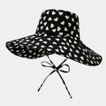 Detail of black sun hat with white heart pattern and adjustable windproof bow straps - One Size / Black