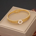 Macro detail of gold flower bangle with white enamel petals and central rhinestone - White Plum Blossom Hollow Buckle Style (5#)