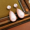 Detail view of teardrop pink crystal earrings on a vintage wood frame and green fabric - Silver Needle Pink Waterdrop Style / Pink