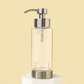 Transparent glass soap dispenser with brushed metal pump on white hexagonal display stand - Empty Bottle