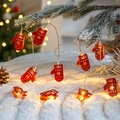 Christmas LED string lights with red hollow glove shades emitting warm yellow glow - Red Glove