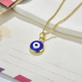 Close-up of golden evil eye pendant with blue enamel on textured stone background - Necklace Set-Navy Blue