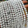 Detailed macro view of natural white turquoise beads with grey webbed marble patterns - Natural White Turquoise/Howlite 4mm (Approx. 90pcs) Strand