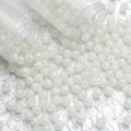 Macro shot of 10mm white ice-crackled glass beads spilling from plastic tubes for DIY - 10mm / White