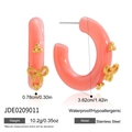 Detail of C-shaped pink hoop earrings with gold bow and bead accents on white background - Resin Bowknot Hoop Earrings (JDE0209011)