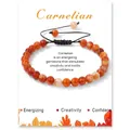 Handmade carnelian bead bracelet with adjustable black braided rope on display card - Red Agate
