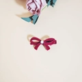 Dark red velvet bow hair clip with white pearl detail on a minimalist beige background - Red Flocking