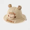Detail of embroidered teddy bear and Luck text on a khaki cotton toddler bucket hat - 50cm(1-2 Years) / Khaki