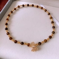 Detailed view of beaded tiger eye necklace with a crystal bow pendant in a gift box - Bowknot Tiger Eye Necklace / Gold