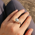 Detail of silver U-shaped open ring featuring a large grey pearl on the hand - Adjustable Open / White Gold