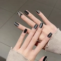Close-up of black cat-eye press-on nails featuring a large silver butterfly charm - By1719 Tianxiang Guose / Glue Type