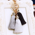 Close-up of gold clasp with elegant black, grey, and white silk tassels on a keyring - Black Gray White