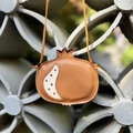 Detail shot of a brown pomegranate-shaped children crossbody bag with lychee texture - Pomegranate Brown