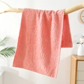 Pink coral fleece face towel featuring embossed bear and floral patterns on a branch - Pink