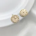 Macro shot of 14K gold-filled clock pendant with 12 zircon markers and a smooth back - Clock Face Round Pendant 14.7mm