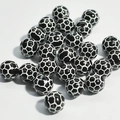 Detailed close-up of acrylic soccer-themed beads for DIY children's jewelry making - 10mm Football Black Background White Line