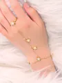 Detailed shot of a gold star hand harness with star pendants on white faux fur background - Gold