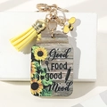 Dettaglio portachiavi in legno a girasole con nappa in pelle e ciondolo ad ape - Stile Good FOOD Good Mood (1)