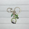 Cute panda keychain with bamboo pendants in gold metal finish and green enamel accents - Panda on Back