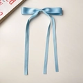 Close-up of light blue ribbon bow hair clip with long streamers on a white background - Sky Blue
