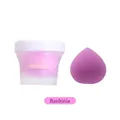 Detail view of purple teardrop makeup sponge with clear peach beauty blender storage jar - Redbud Flower