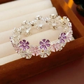 Detailed close-up of colorful enamel flower bracelet in a jewelry box - Silver Pink Purple