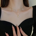 Detail of double-layer gold necklace featuring ball chain and oval pendant on collarbone - Pearl Pendant Style (20#)