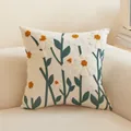 Square cream throw pillow cover with floral 3D embroidery on a minimalist sofa - Narcissus