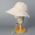 Detail view of adjustable grey chin strap and buckle on cream wide brim sun hat - Off-white