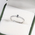 Detail of silver plated letter ring with zircons in a green and white jewelry box - Platinum I