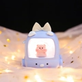 Cute TV shaped night light in blue with small pink pig figure inside a bow decor - Night Light / Blue Pig