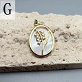 Macro shot of oval white shell flower pendant with gold leaf accents on stone - Style G