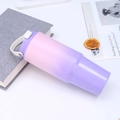 Detail of 30oz gradient pink-purple insulated tumbler with white handle on a white desk - Peach Purple Gradient