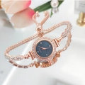 Elegant rose gold quartz watch with rhinestone bezel and navy blue dial on a pink background - Rose Gold Case Blue Dial