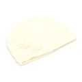 Close-up of cream white knit beanie with vertical ribbing and handmade flower details - One Size / White