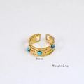 Detail of 14k gold plated ring featuring multiple blue round gemstones and 8mm width - Multi-blue Gemstone Inlaid Style