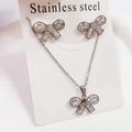 Detail view of bow-shaped stainless steel necklace and earrings set with clear crystals - Set 2712 Steel Bowknot