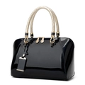 Glossy black patent leather Boston bag with golden woven handles and zip closure - Black