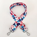 Detail of colorful floral fabric shoulder strap with silver metal buckles and adjusters - Pink Floral / Silver Clasp