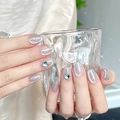 Close-up of silver cat-eye press-on nails with blue polka dots and 3D heart diamond accents - By1626 Is Beautiful Inside And Out. / Glue Type