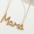 Golden mama letter necklace with colorful small gemstones on a white background - MAMA Double Chain