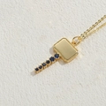 Gold hammer pendant necklace with blue cubic zirconia stones on stone background - Large Key / Gold with Royal Blue Zircon