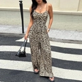 Chic leopard print backless jumpsuit with wide leg design worn by a model in street style - XL / Leopard Print